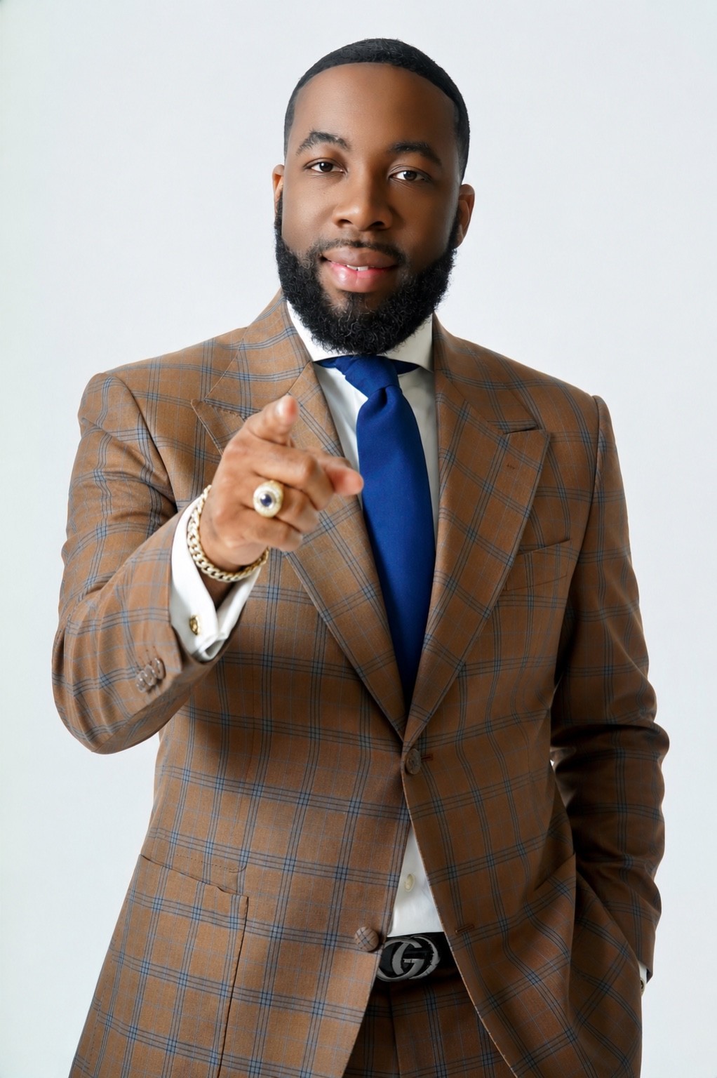 Bishop Dr. Justin Marcus in a brown plaid suit